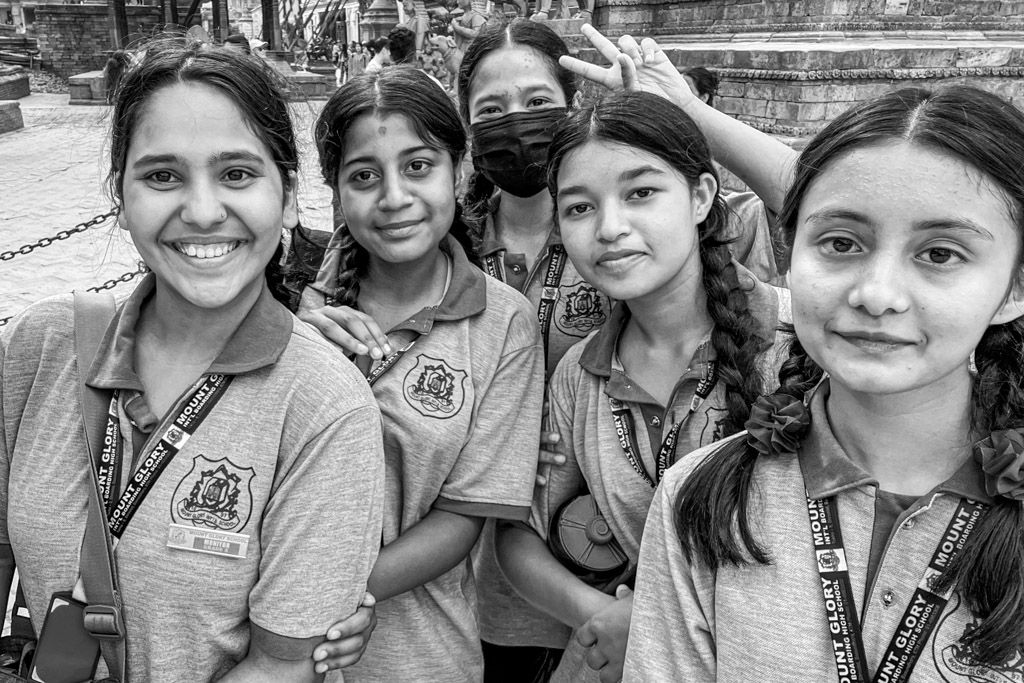Black & White image of Newari school girls in Kathmandu, Bhaktapur, Nepal.  Street scene by Emma Drohan