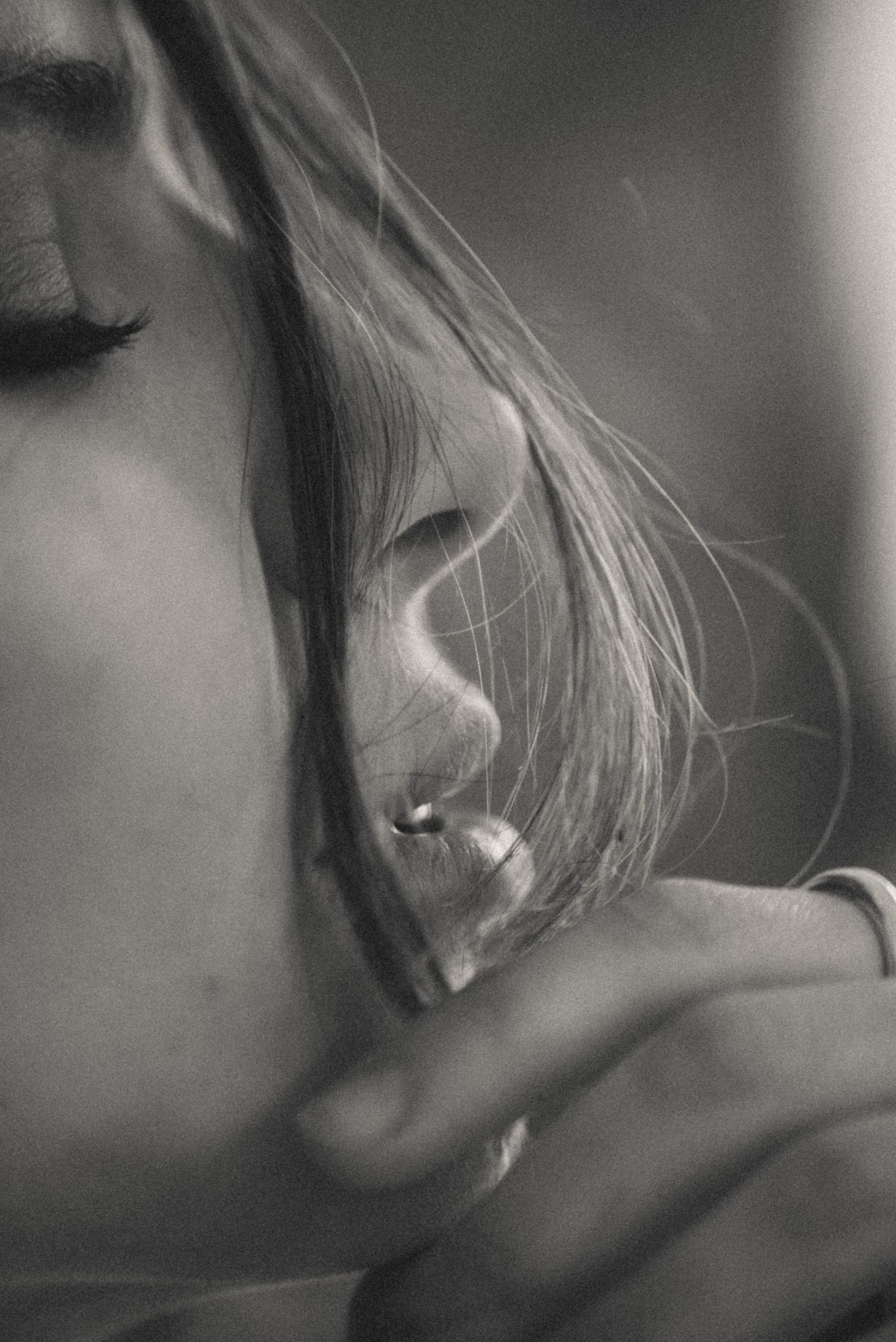 Black and white close-up portrait series with dreamy, out-of-focus aesthetic.
