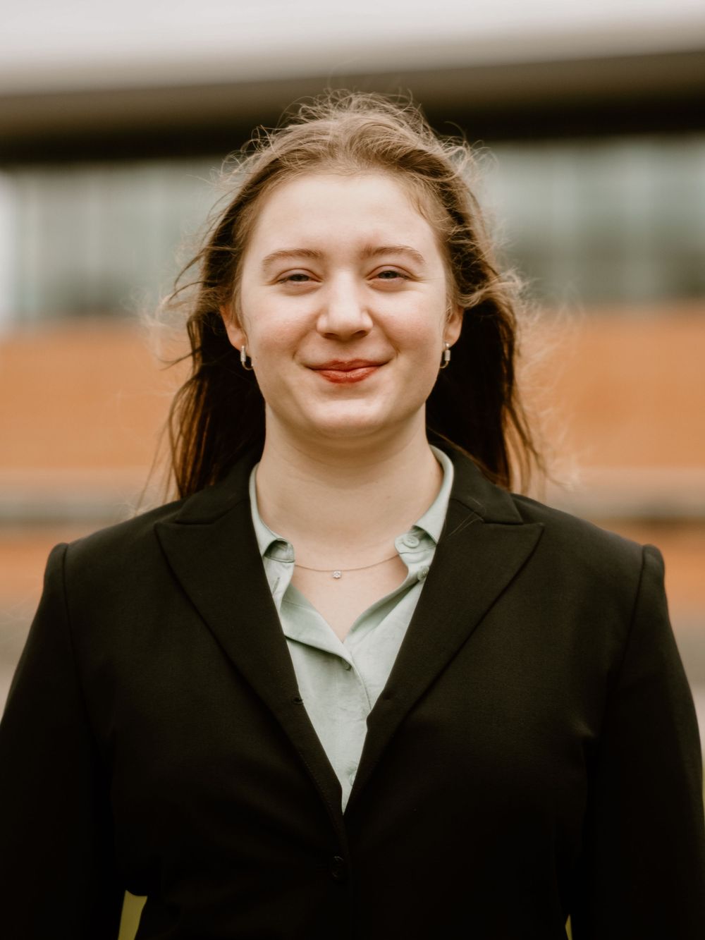 A person smiling while wearing business attire in a professional headshot style photo.
