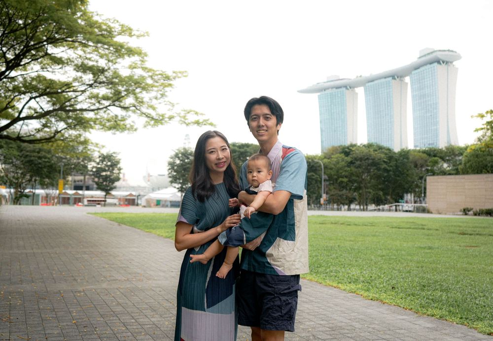 Family enjoying outdoor time with Marina Bay Sands in background.