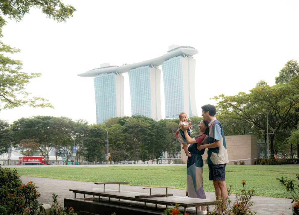 Scenic family photo with Marina Bay Sands towers in Singapore background.