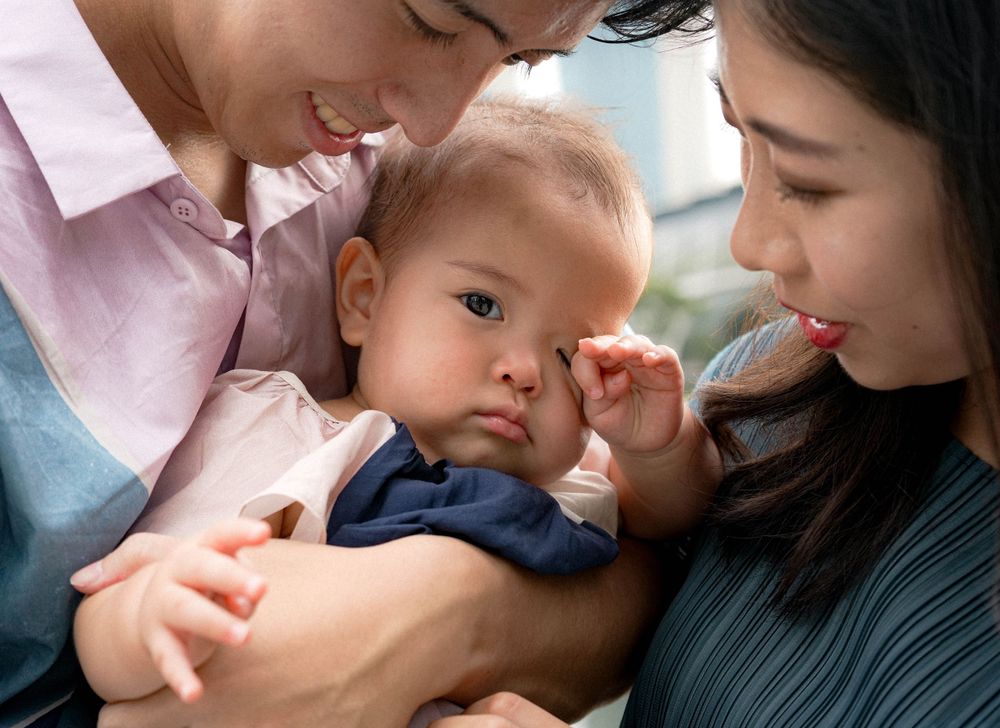 An intimate family moment captured in front of Singapore's Marina Bay Sands.