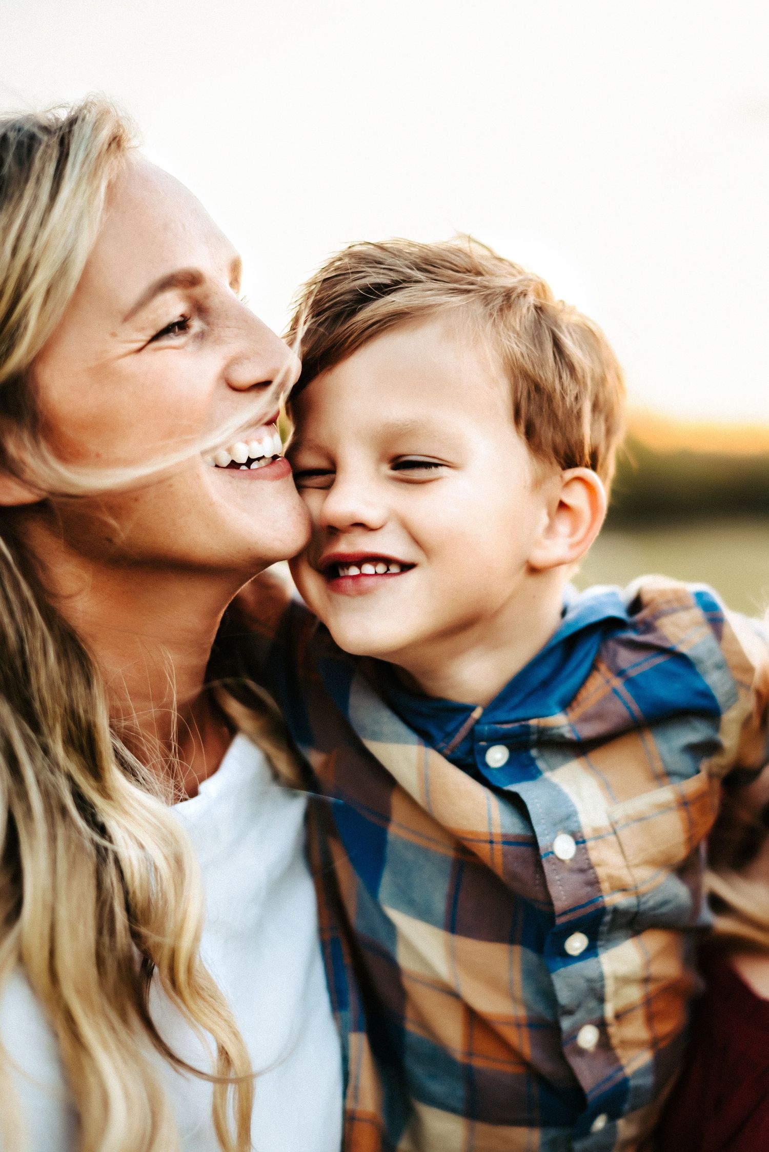 A joyful moment captured during sunset showing pure happiness and laughter in a candid photo.