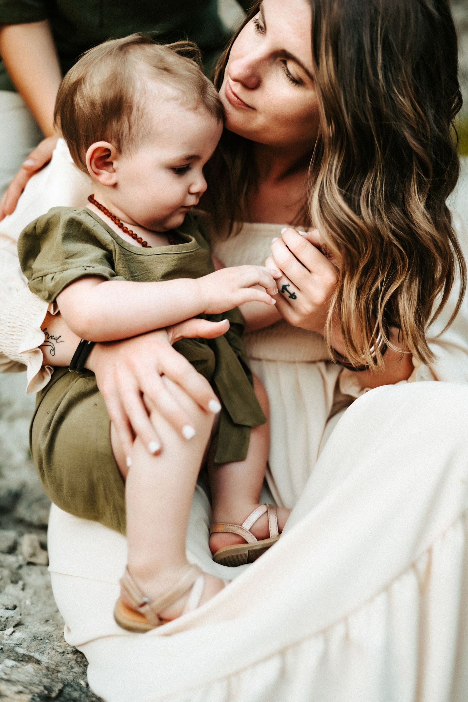 A tender moment captured between parent and young child in soft natural lighting against a blurred background.