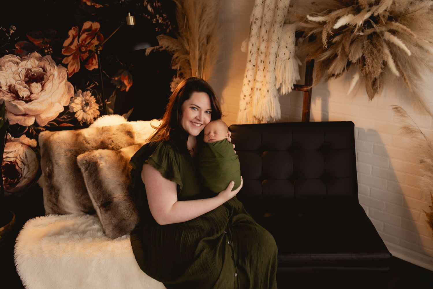 Mom snuggling newborn baby boy during a cozy studio session with Urso Photography.