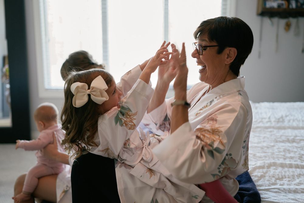 People dance and celebrate together in a joyful moment as seen through a vintage-style photograph.