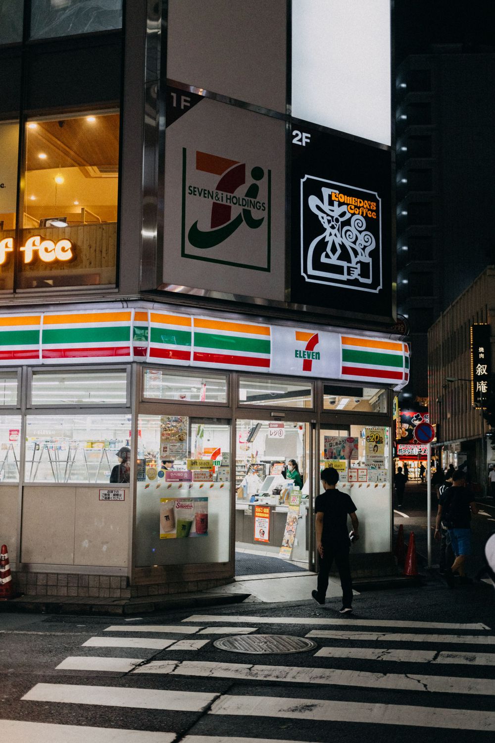 7-Eleven convenience store at night with illuminated signage in Japan.
