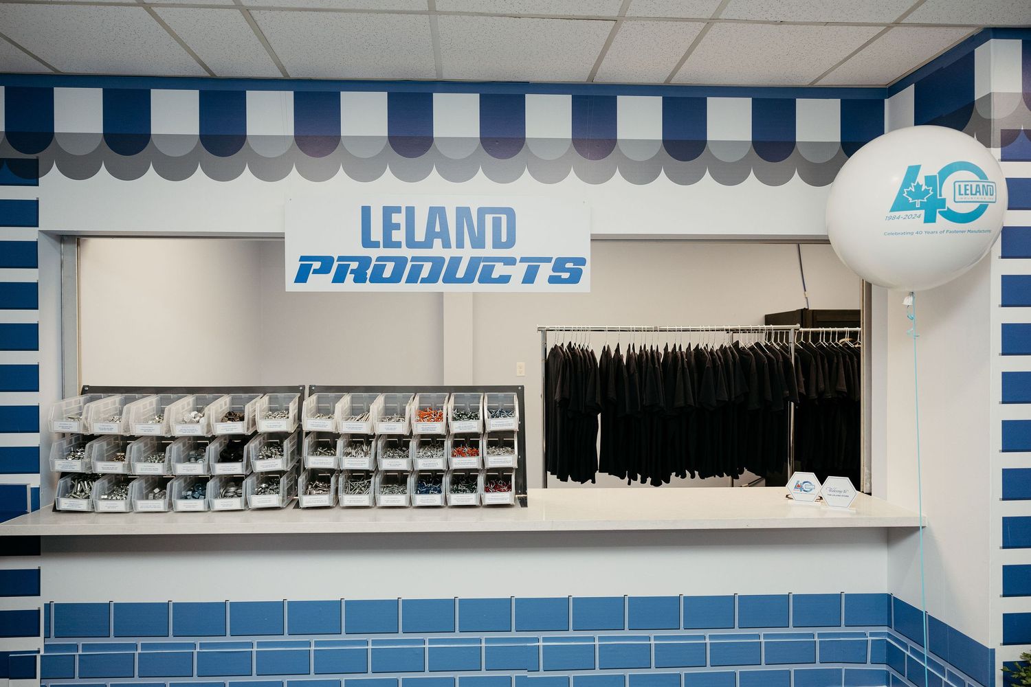 Interior view of Leland Products showroom with blue and white storage bins on wall.