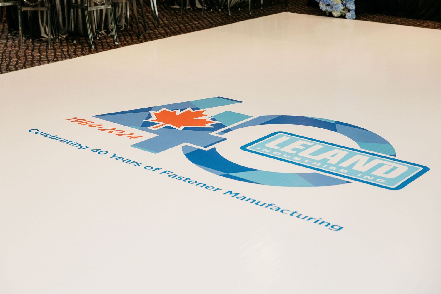 Corporate logo designs and branding elements in blue and orange colors on a white surface.
