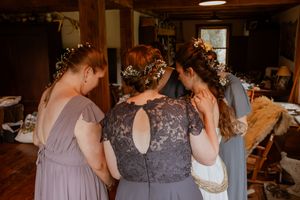Wedding party members share emotional moments during preparation.
