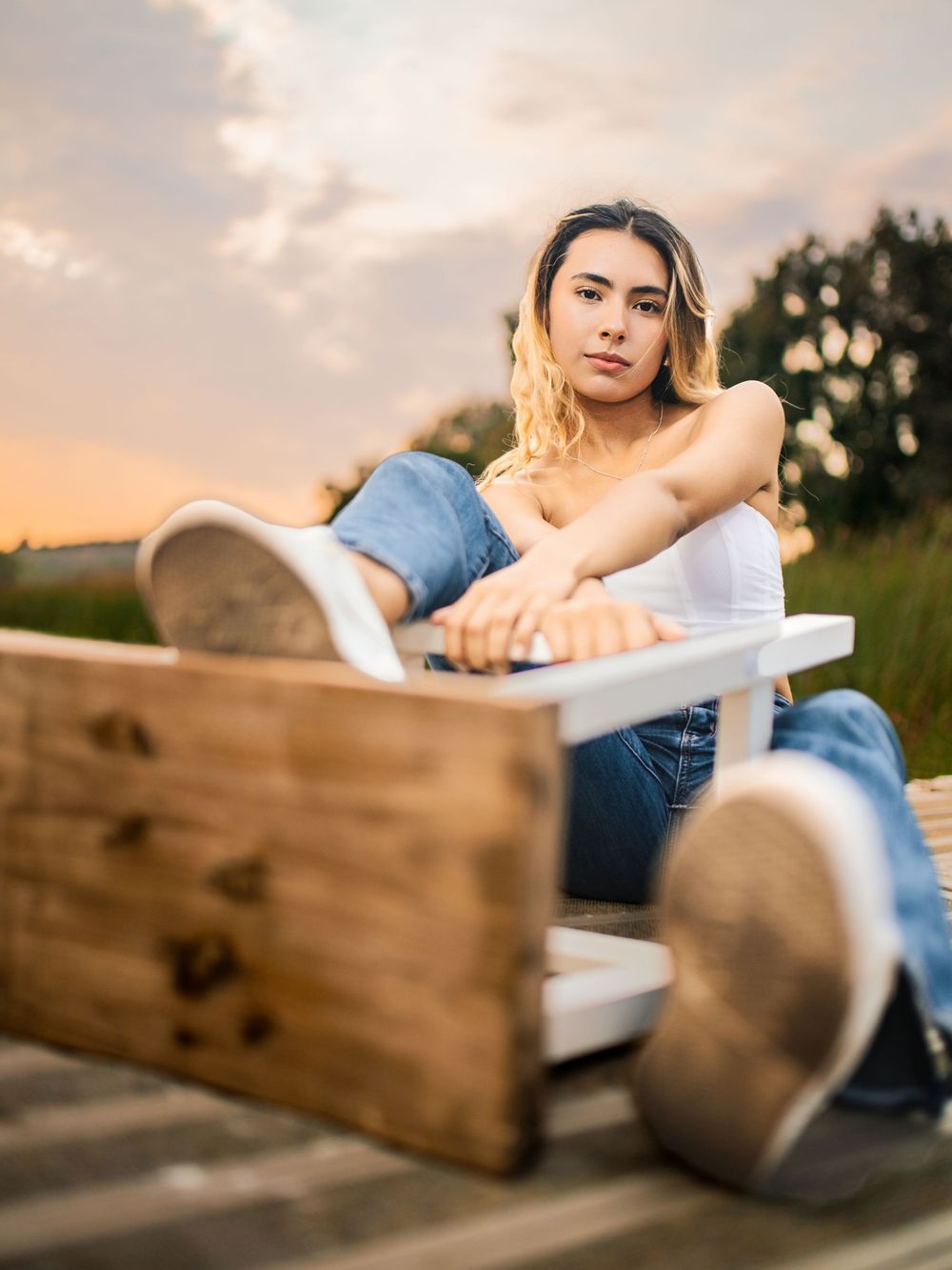 Casual outdoor portrait at sunset sitting on wooden deck.