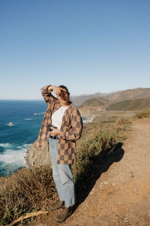Coastal viewpoint overlooking blue ocean waves and rugged California coastline, Big Sur, California.