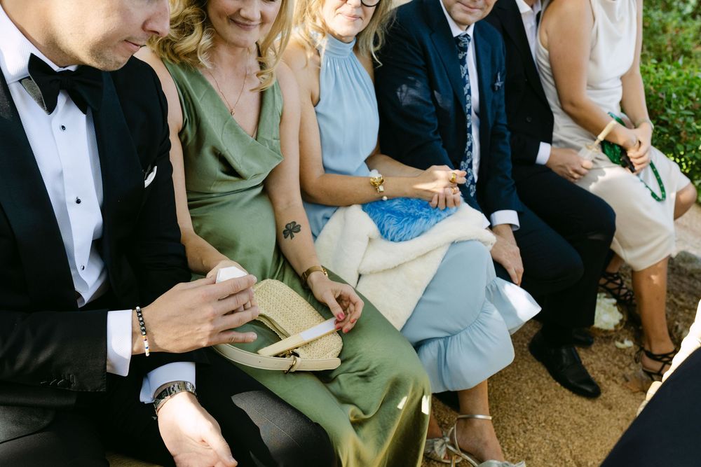 Wedding rings being passed between guests during ceremony ritual in Lisbon destination wedding