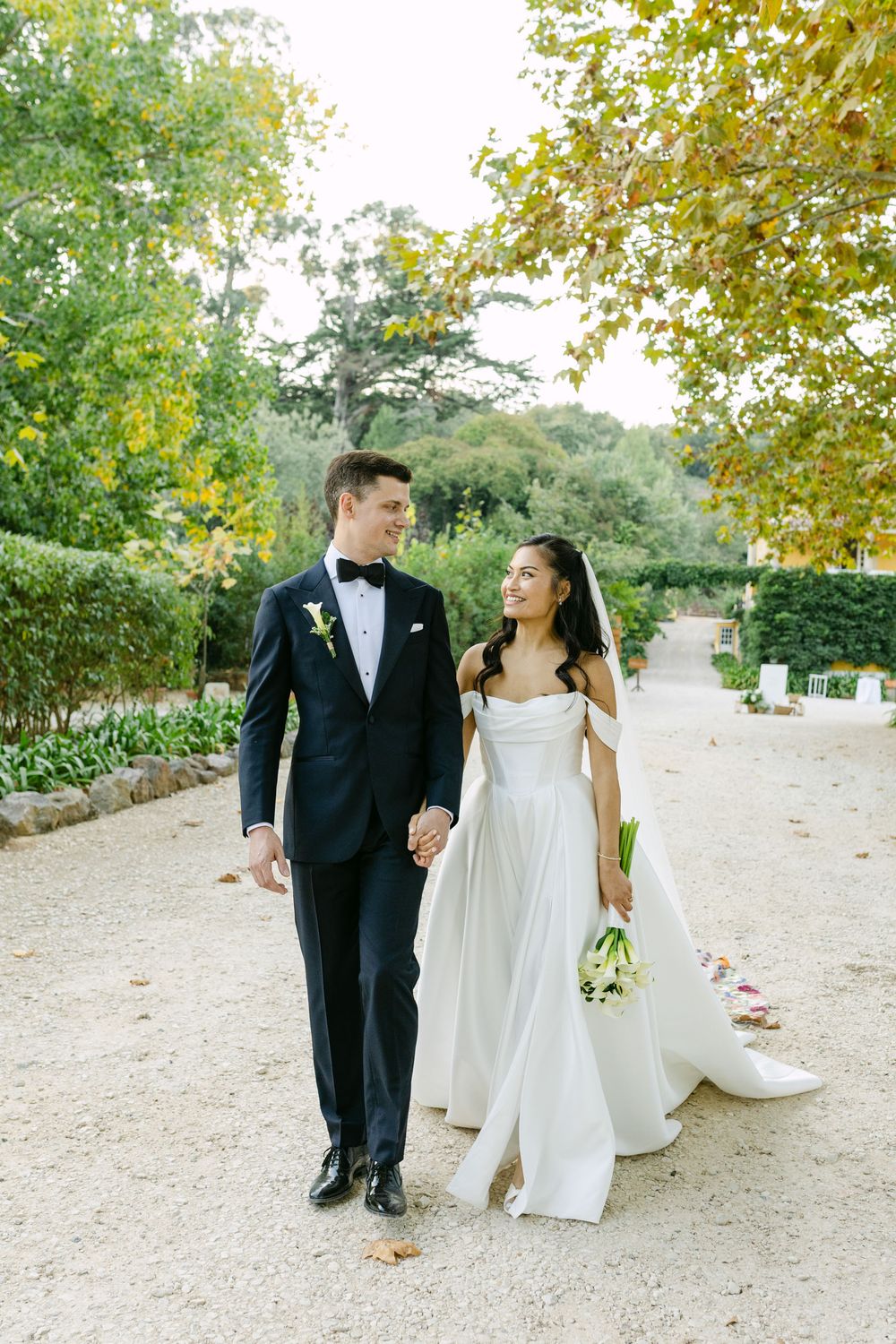 Bride and groom walking hand in hand on garden path at Quinta Nova do Hespanhol Lisbon destination wedding
