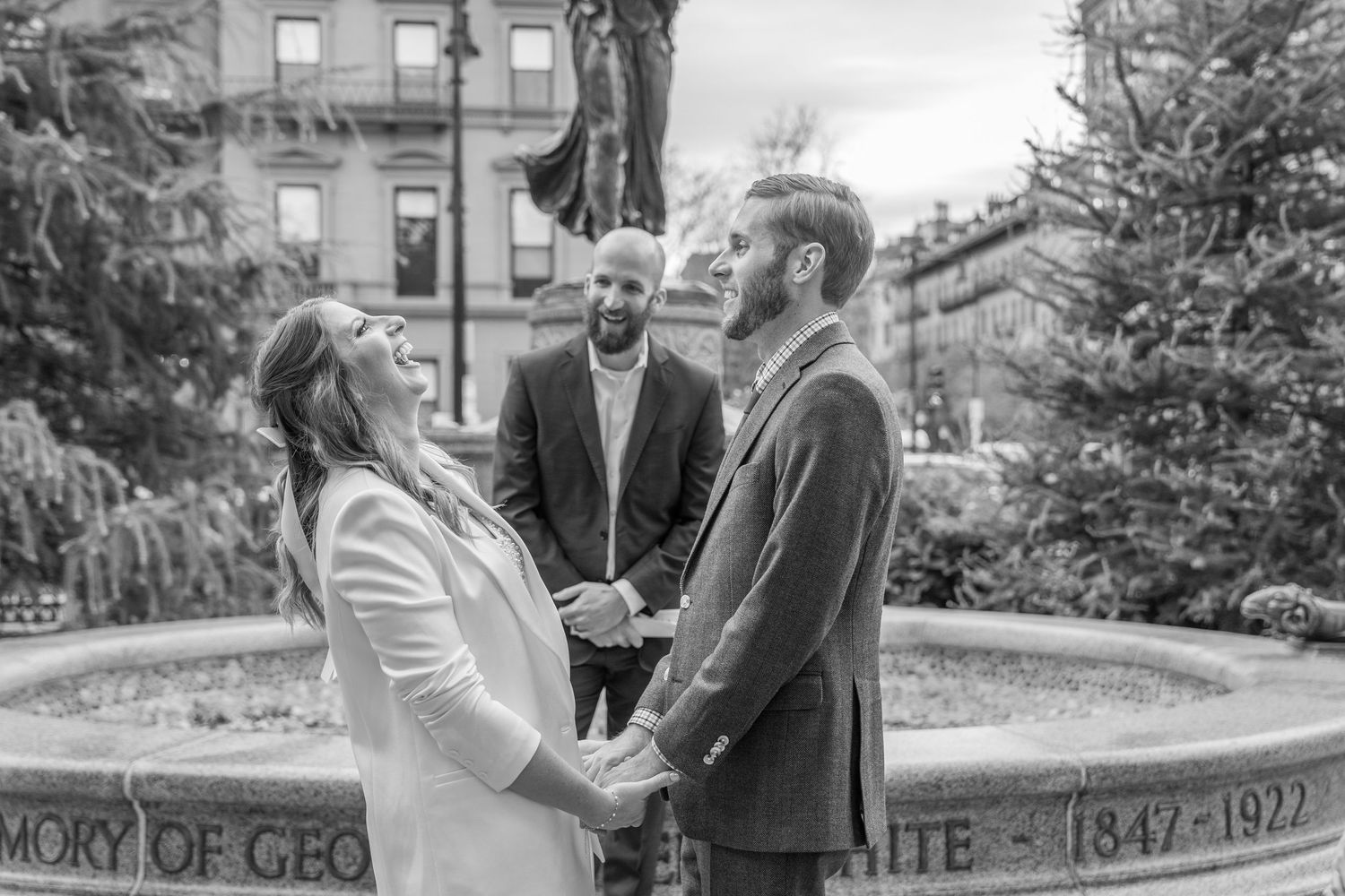 Bride laughing during her wedding ceremony at Boston Public Garden in Boston, Massachusetts.