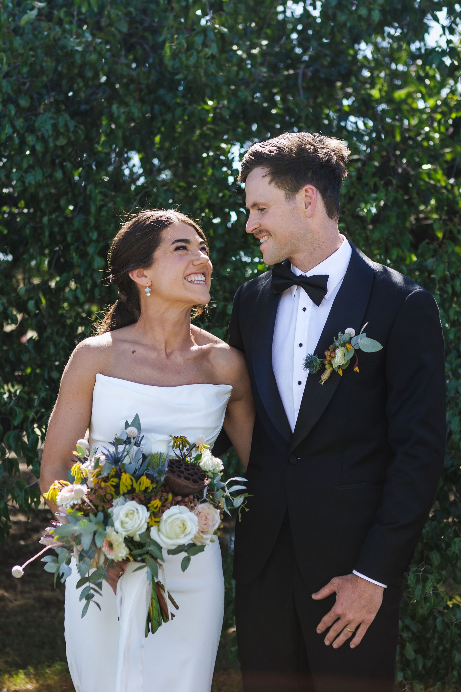 Bride and groom smiling and hugging eachother at NSW Country wedding