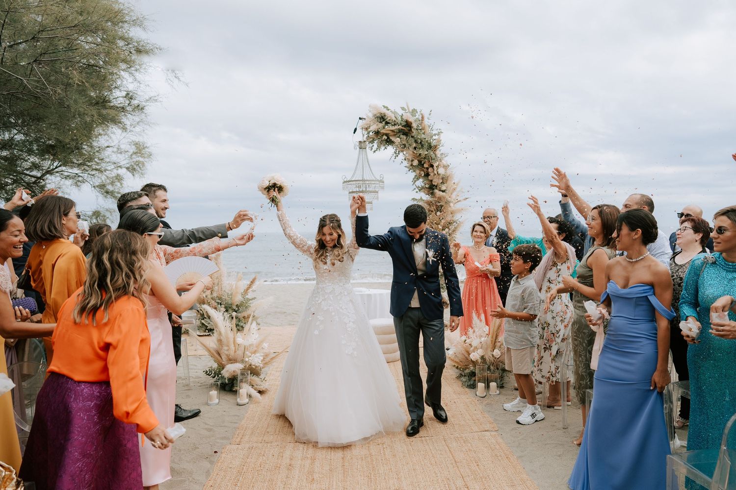 Rice being thrown during the beach ceremony at the wedding venue "La Spagnuola Marchesi Gavotti" in Savona.