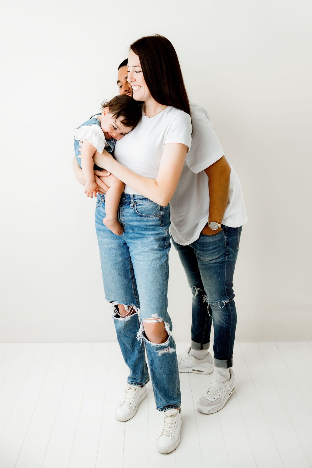 family of three playing peekaboo