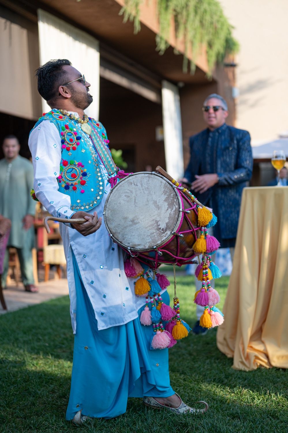 A traditional Dhol player performing in the vineyards of Lake Garda for an Indian celebration