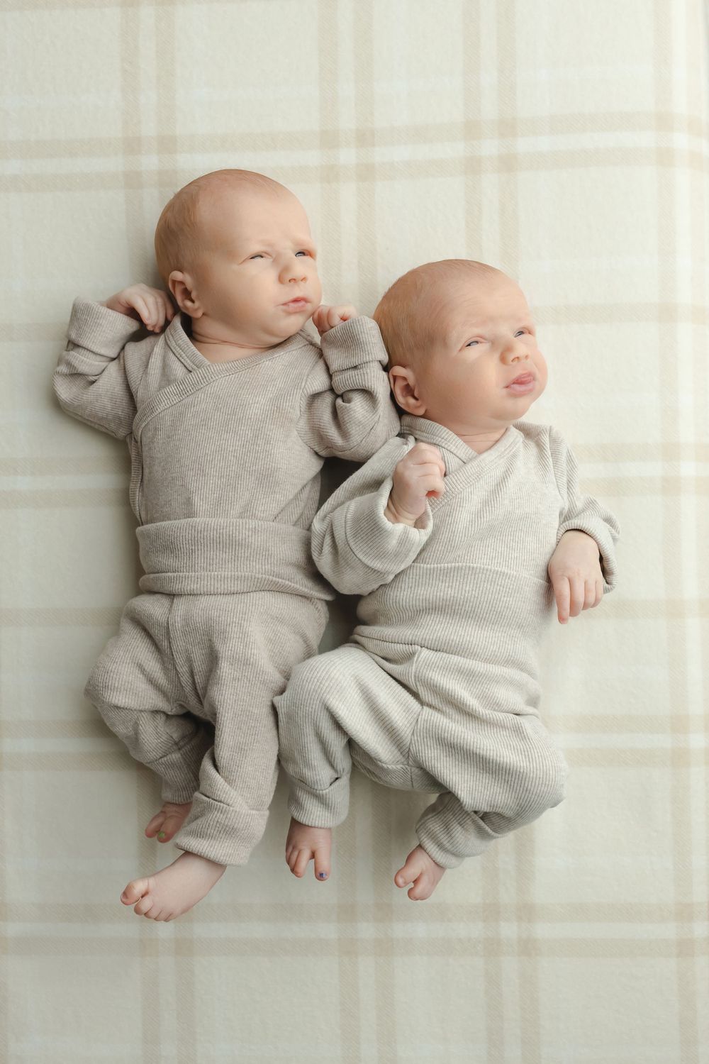 Twin newborn boys on plaid background, taken by Jen Knightstep, Photographer