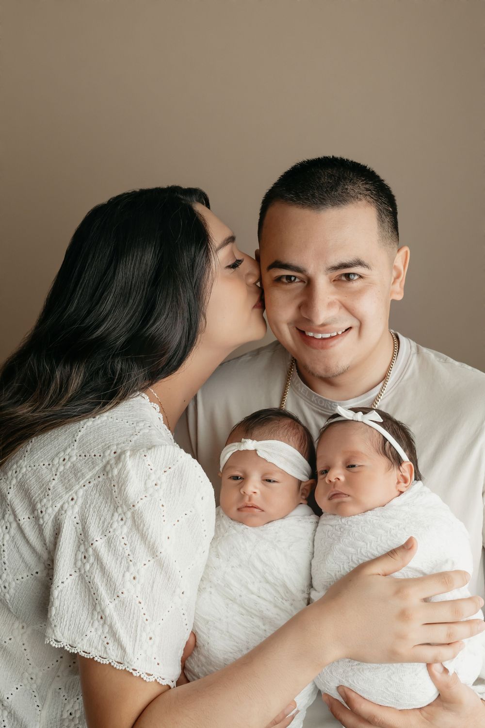 Twin newborn girls, in parents' hands, taken by Jen Knightstep, Photographer