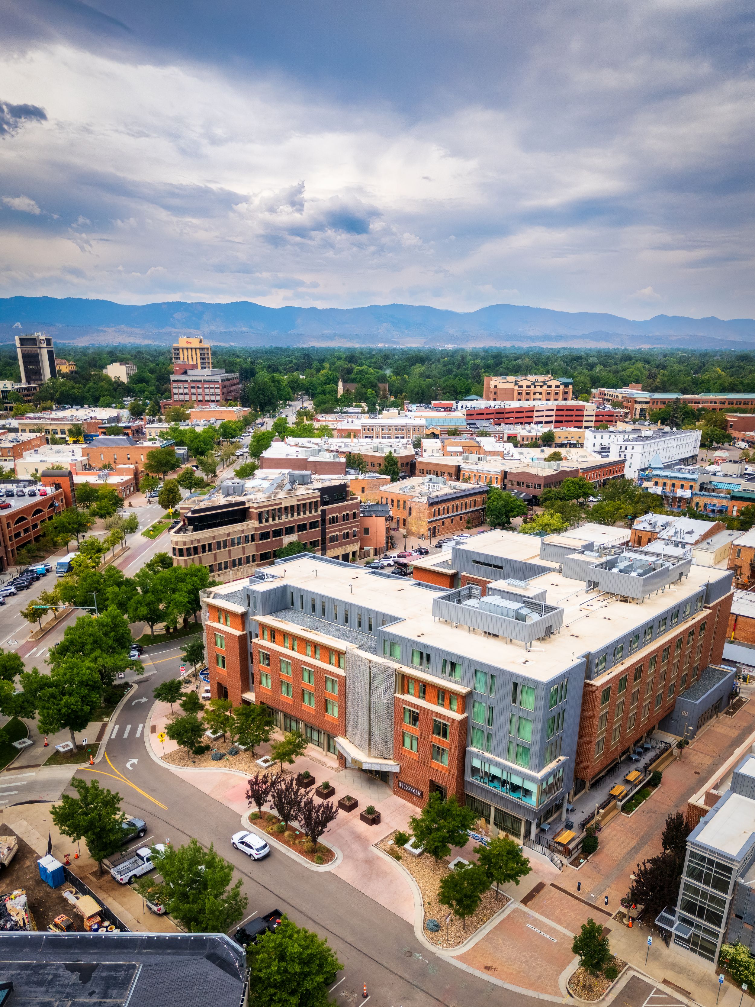 Aerial/drone shot of The Elizabeth Hotel & the mountains by Denver Hospitality, Travel & Tourism photographer Captain Colorado Photography.