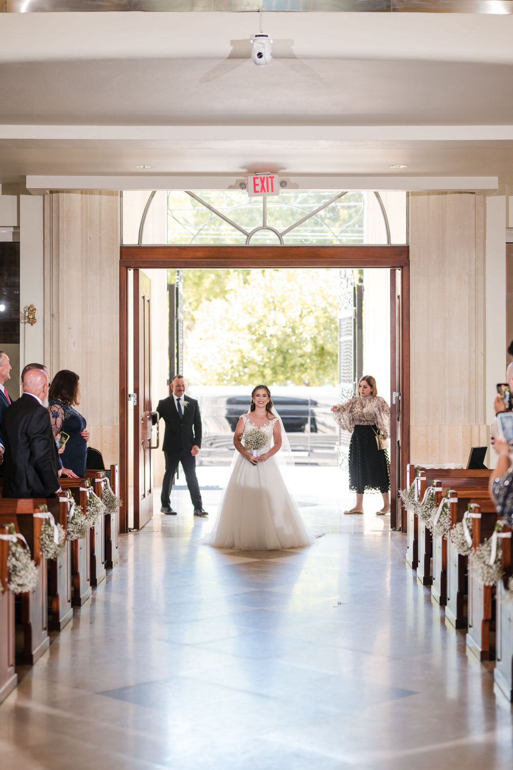Bride walking down aisle during wedding ceremony at Stella Maris Church