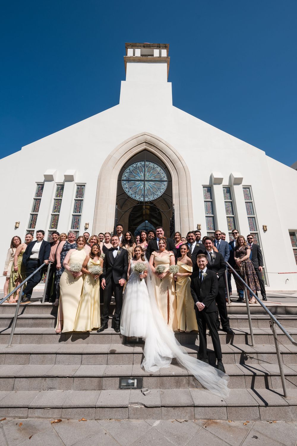 Bride and groom exiting Stella Maris Church with guests celebrating outside in Puerto Rico