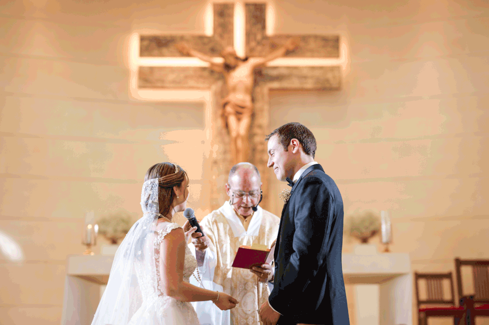Bride and groom exchanging vows at altar inside Stella Maris Church in Puerto Rico