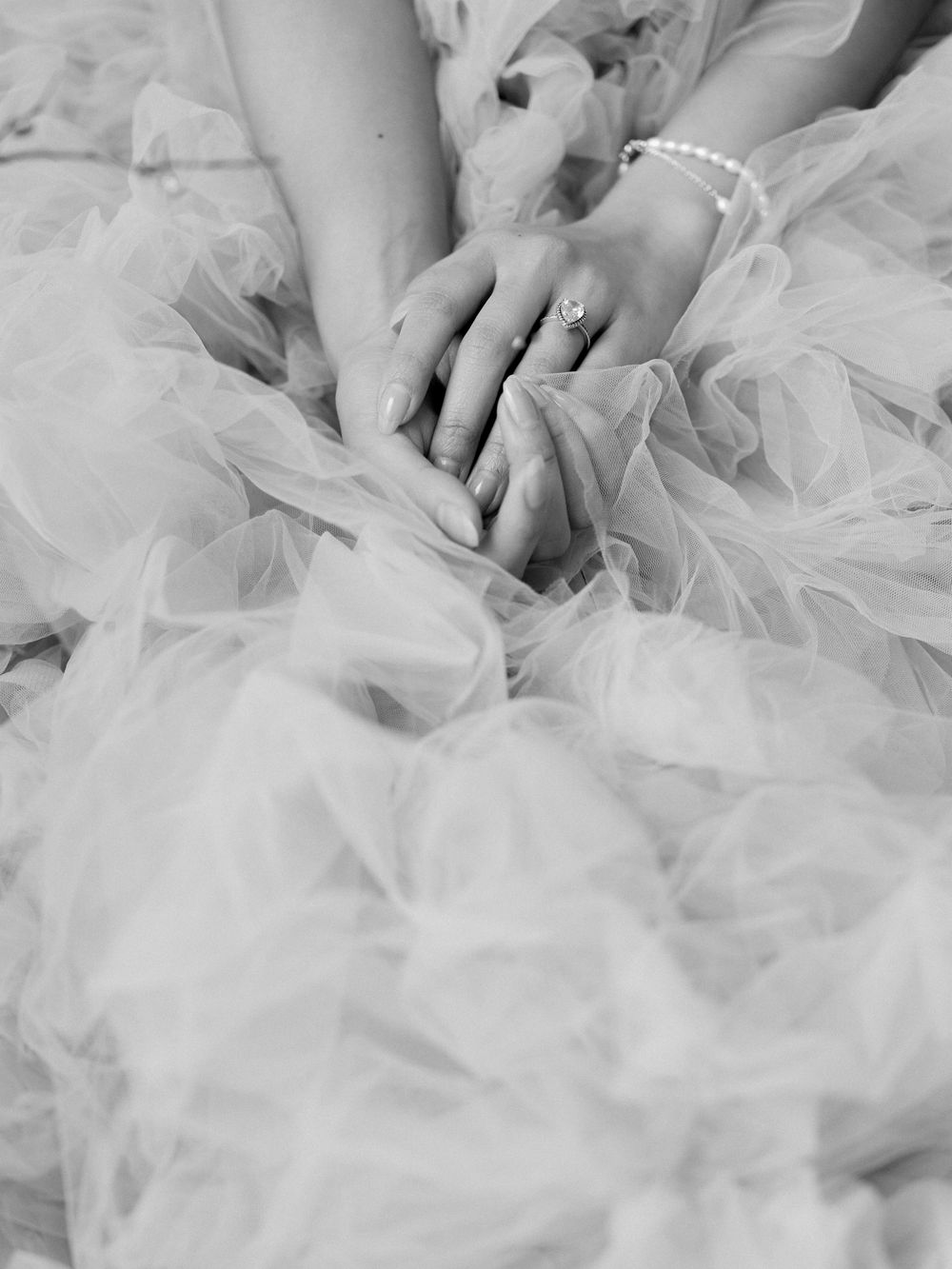 Delicate layers of white tulle fabric create an ethereal texture in soft lighting.