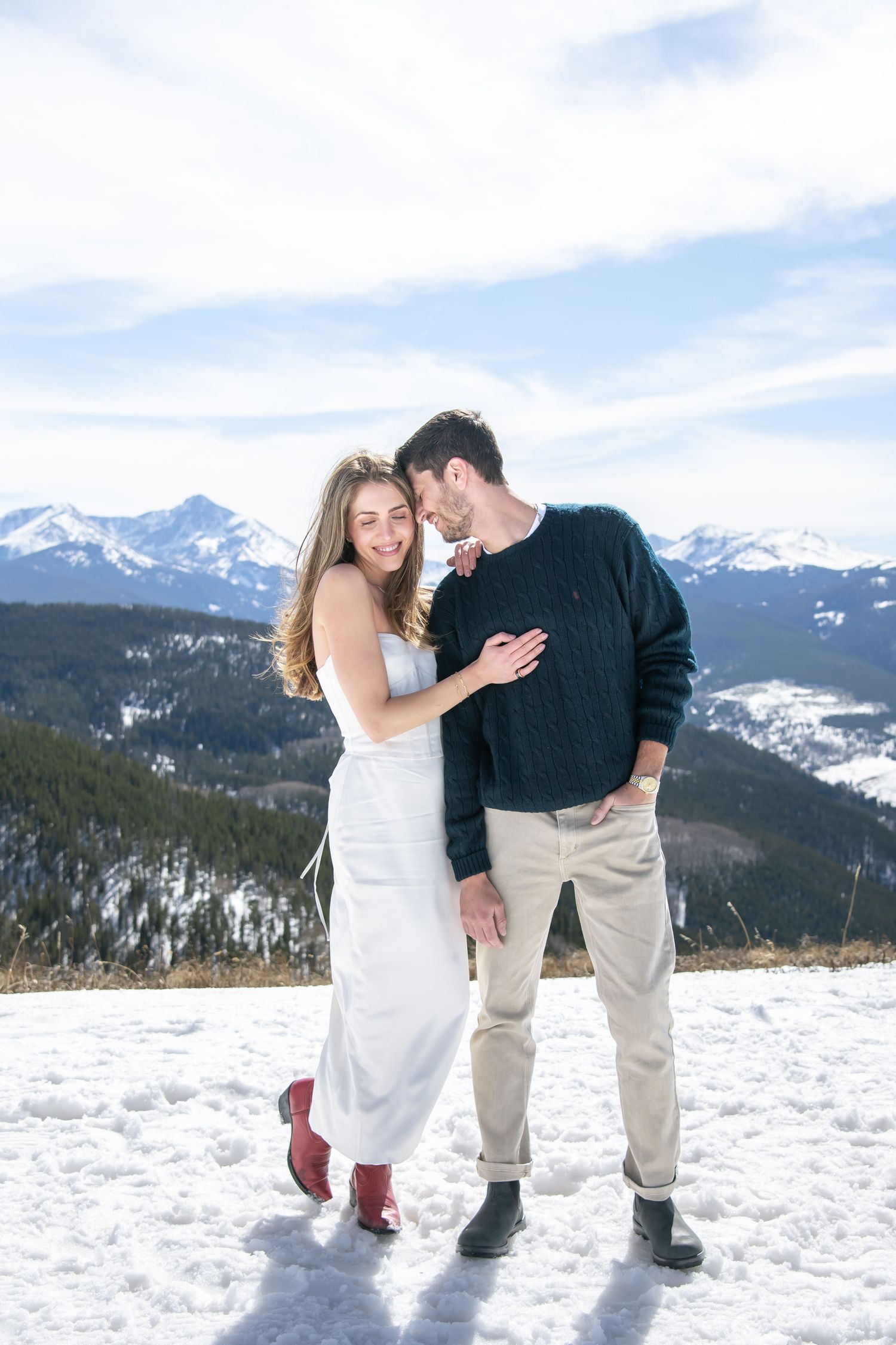Cute candid engagement photos with a chic couple on top of Vail mountain for winter engagement photos.
