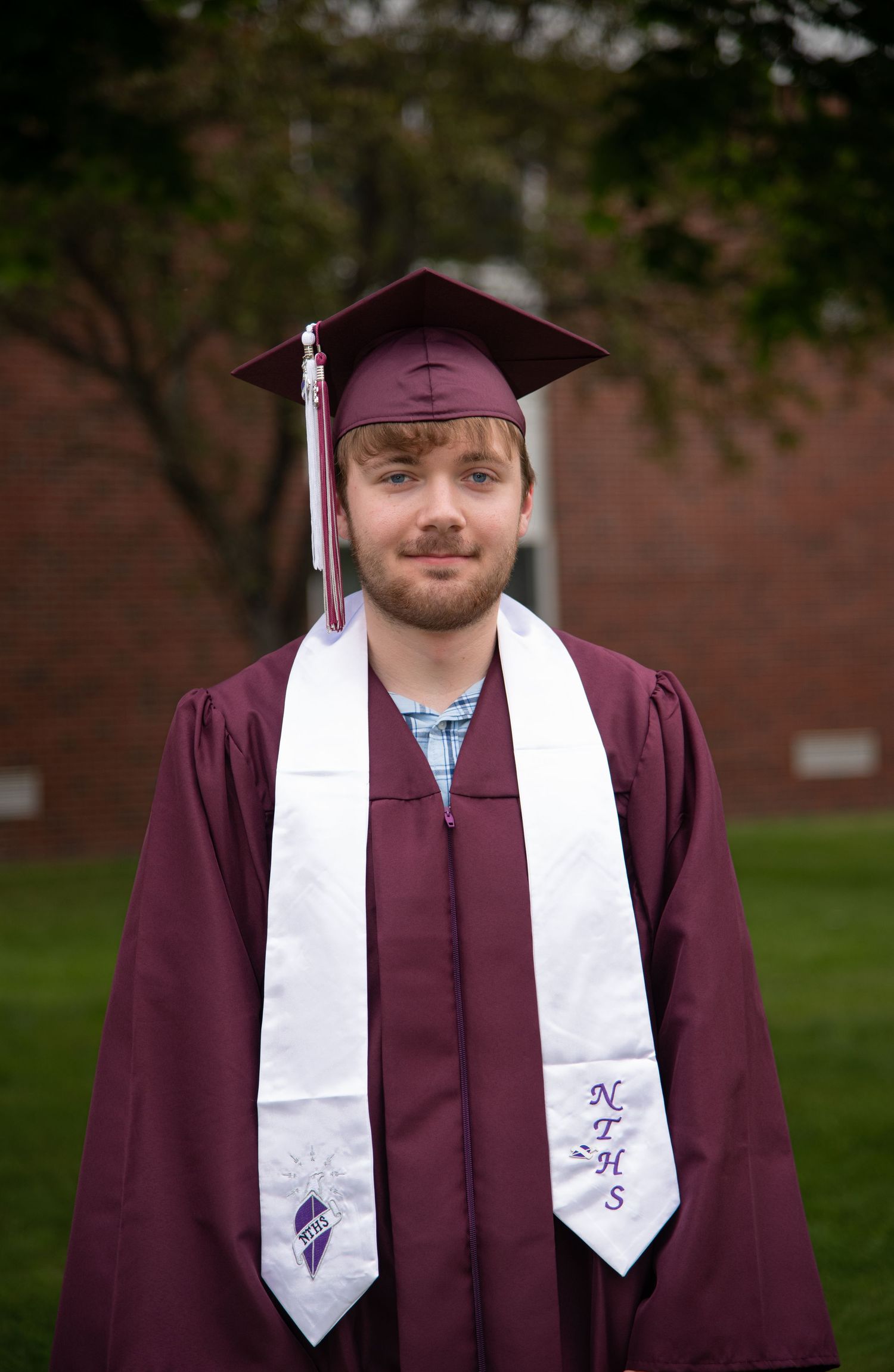A graduation photo series showing someone in maroon cap and gown with white stoles against a brick background.