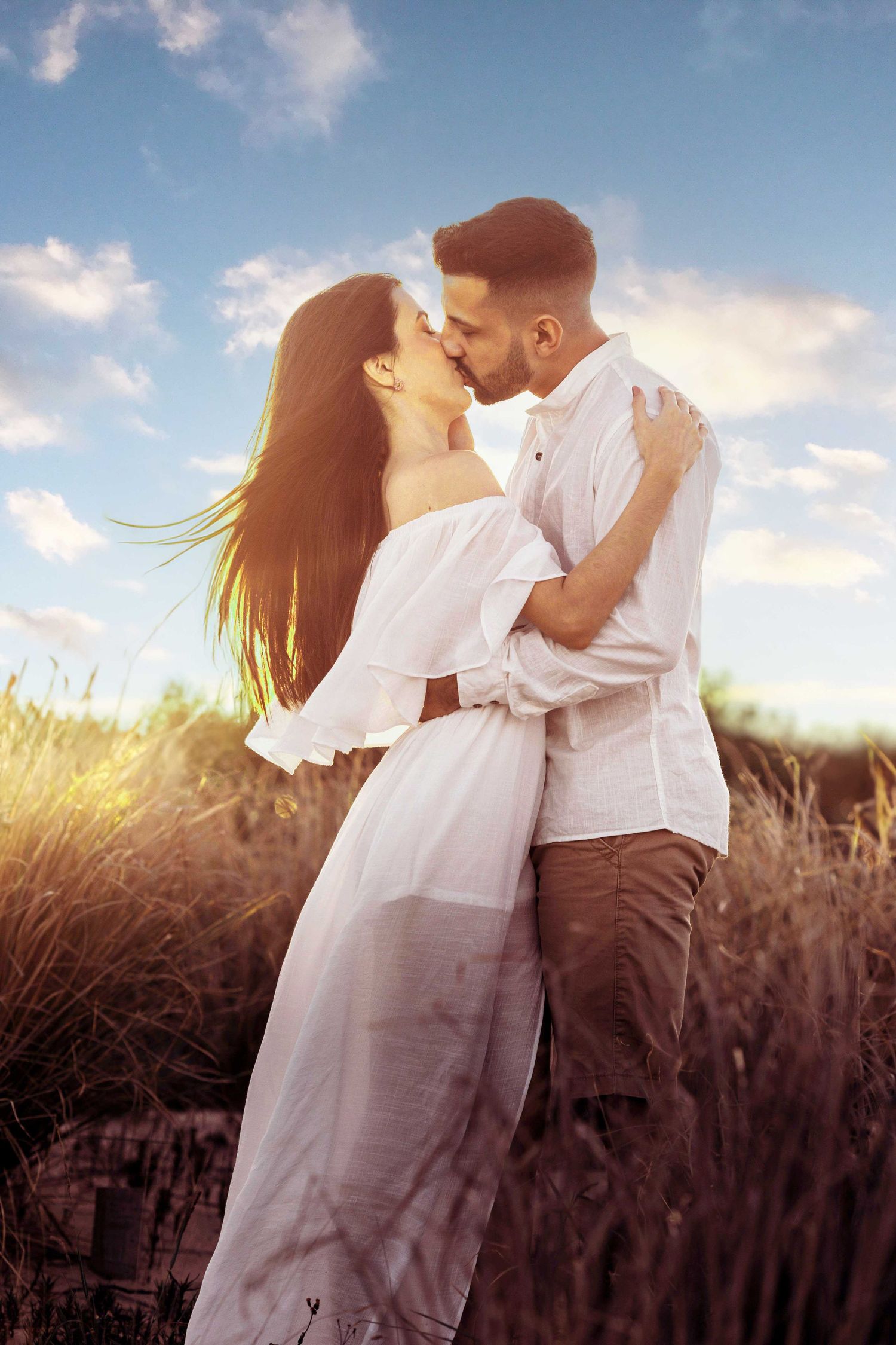 A romantic couple sharing a tender kiss during engagement session