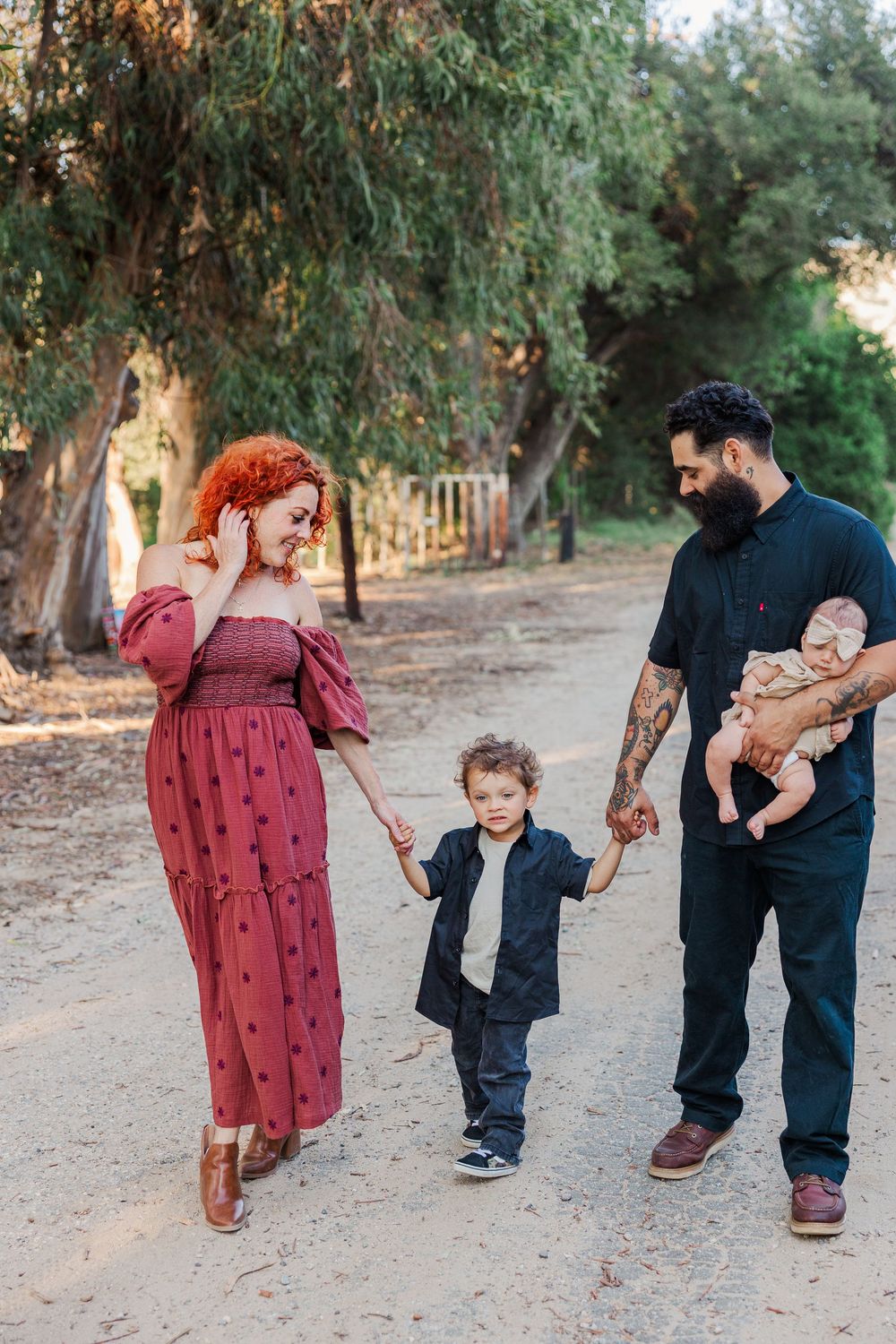 A series of candid walking shots showing a family strolling together on a tree-lined path at sunset.