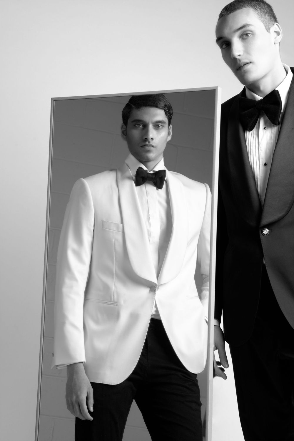 A series of black and white fashion photographs showing models in formal tuxedos and white dinner jackets.