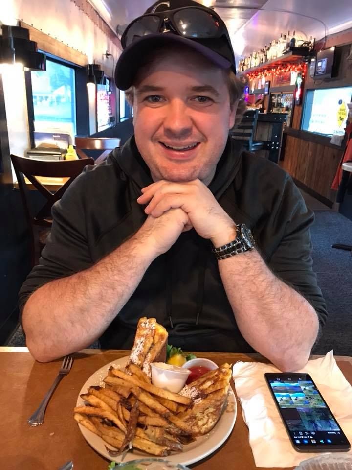 Casual dining scene with french fries and a mobile phone on the table.