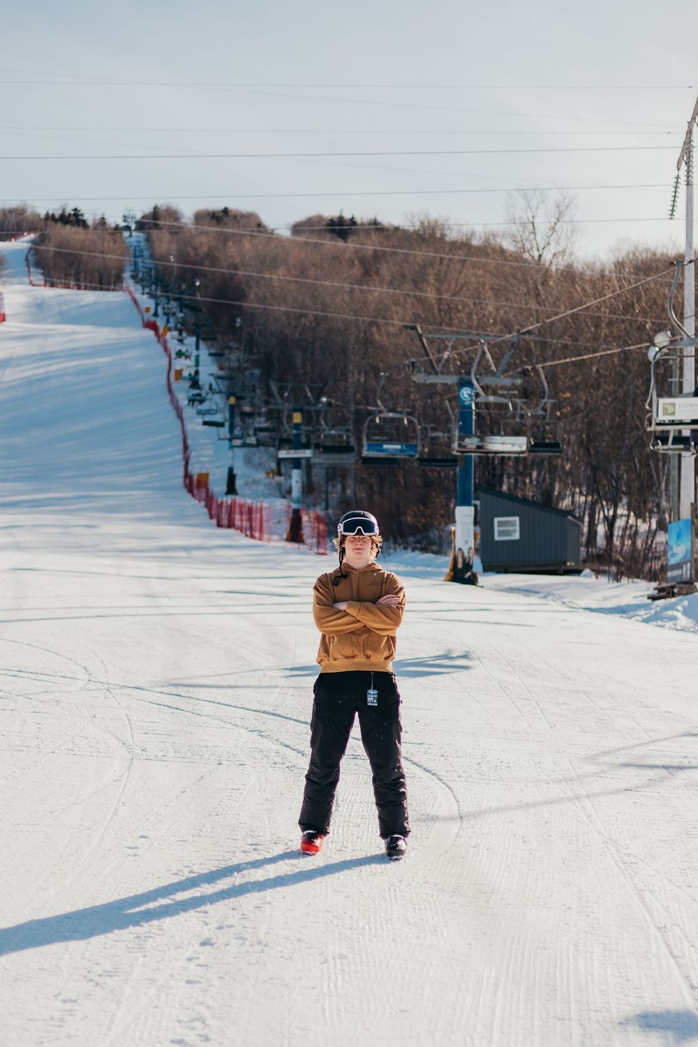 A sequence of five photos showing a skier riding up a snowy ski slope on a chairlift against a winter mountain backdrop.