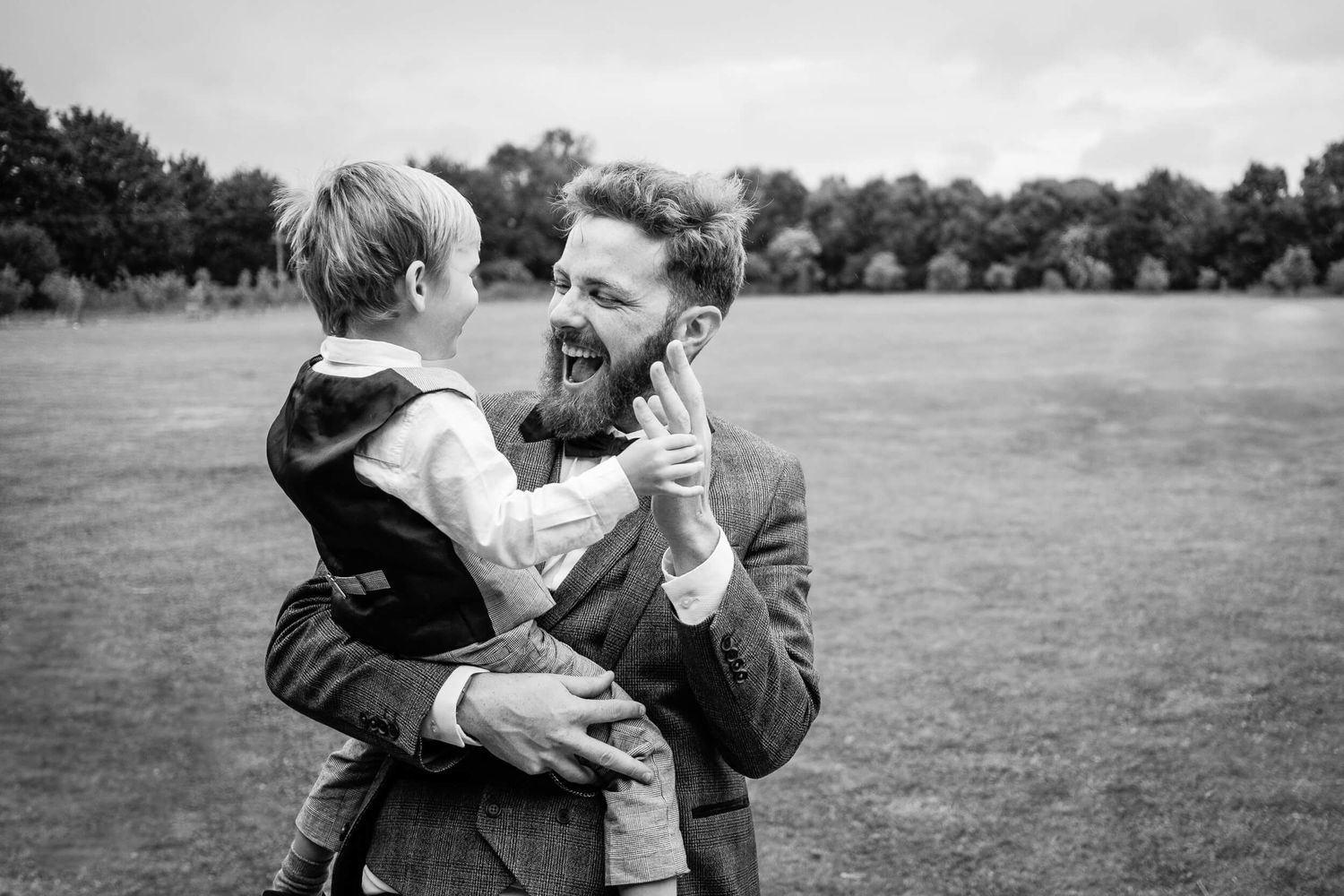 Groom playing with page boy at a wedding
