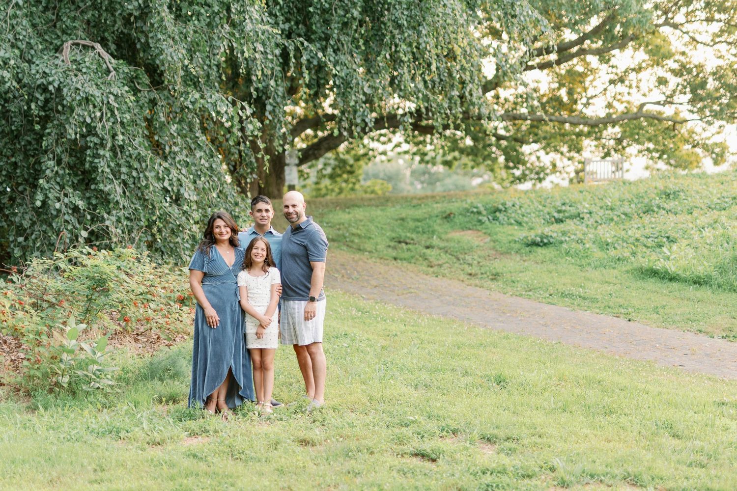 A casual outdoor portrait session under a weeping willow tree.