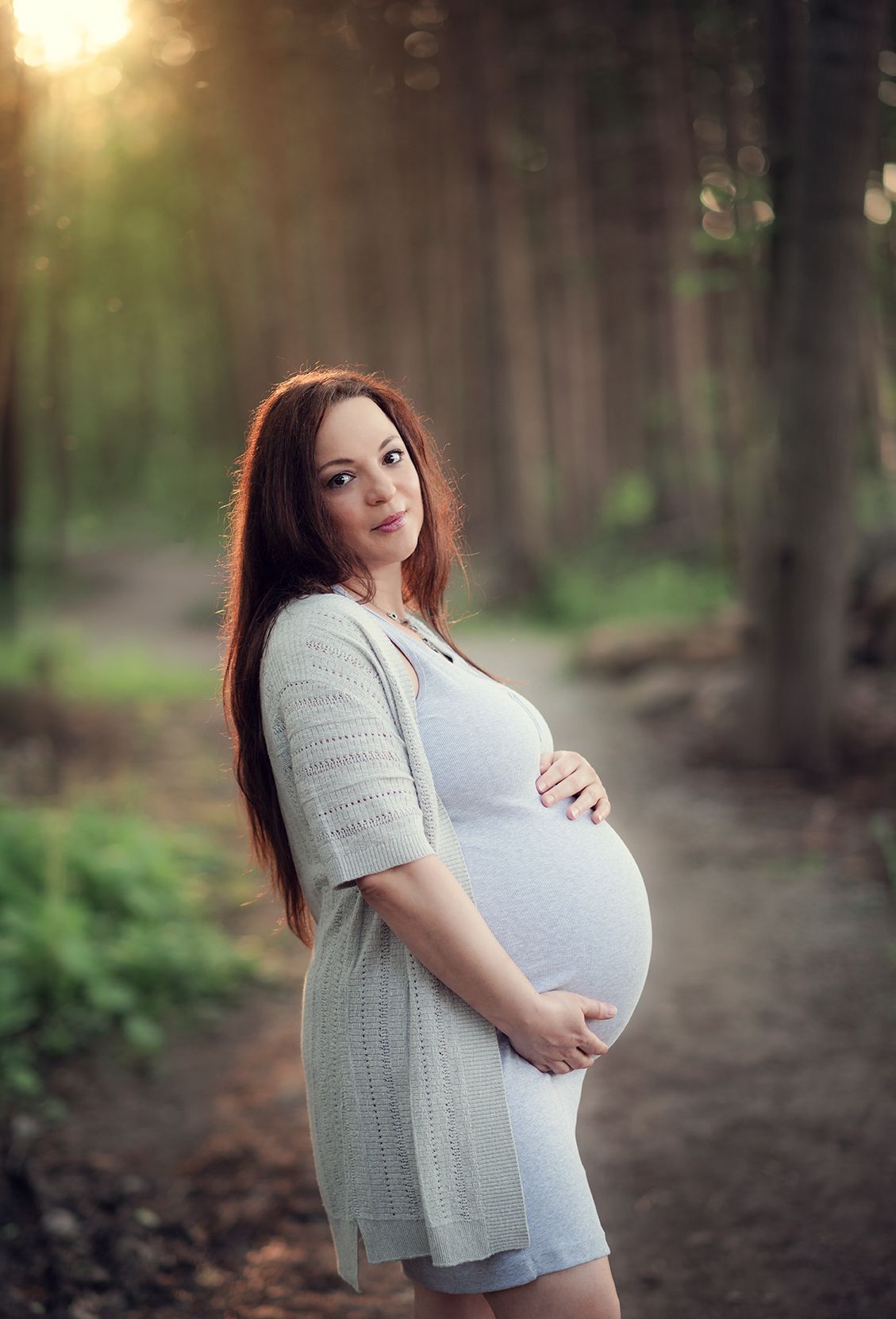 pregnant woman in the forest at Friday Harbour Marina during the maternity photo session in Barrie Ontario