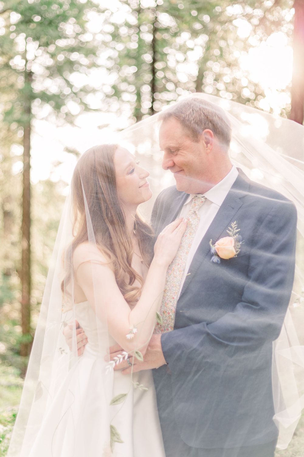 A couple shares tender moments during their wedding photoshoot in a dreamy forest setting.