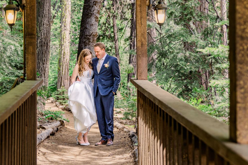 Wedding photos captured along a wooden walkway surrounded by lush forest greenery.