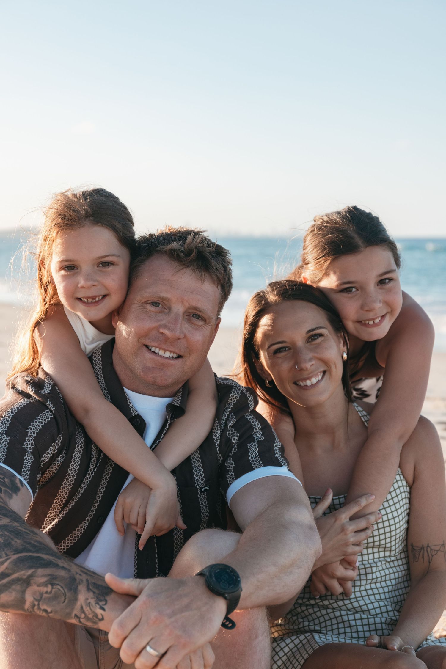 Joyful family photoshoot on Cabarita Headland with warm natural light and sea views