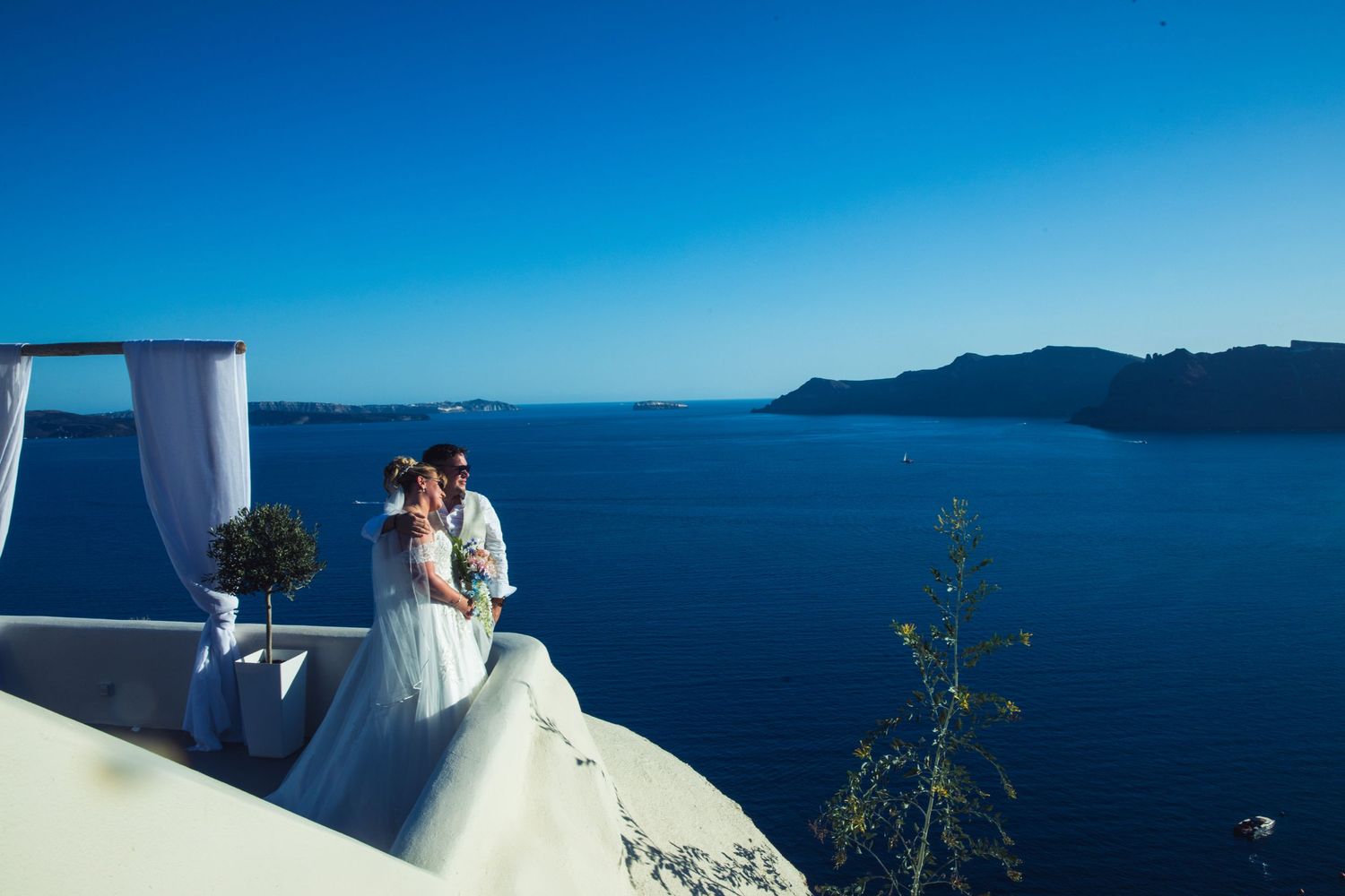Bride and groom candid photo on destination wedding in santorini, greece