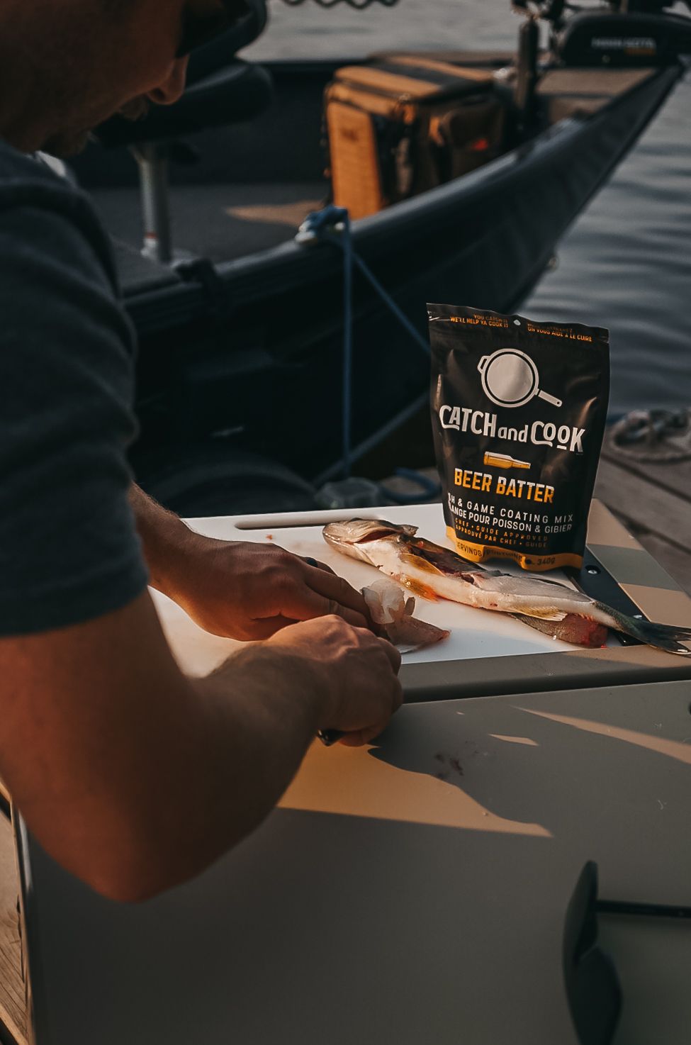 Person preparing food with Catch and Cook beer batter mix on counter.