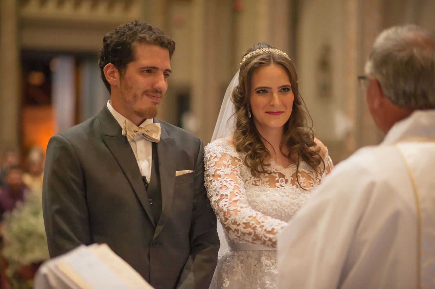 A couple exchanges vows during their traditional church wedding ceremony with an officiant.