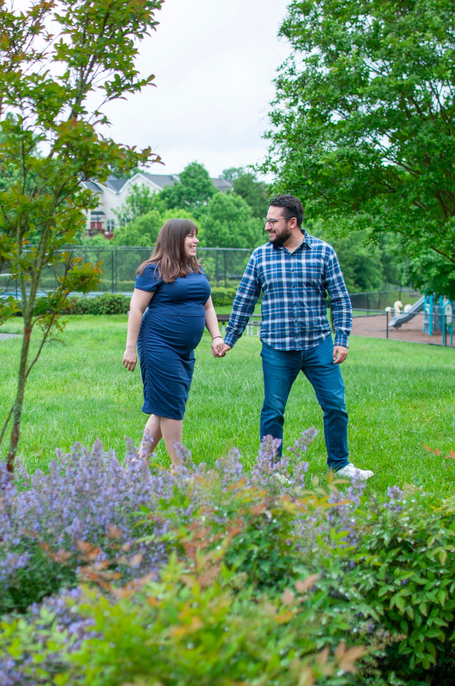 Maternity session couple walking candid photo