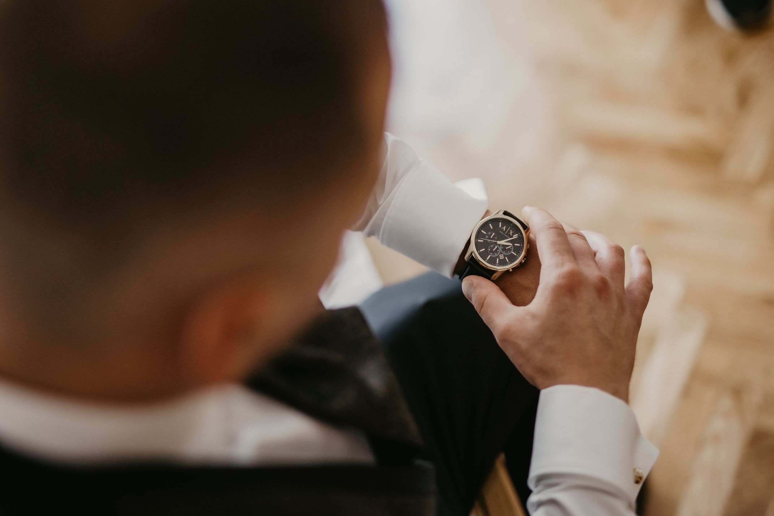 Close-up shot of person checking time on elegant wristwatch.