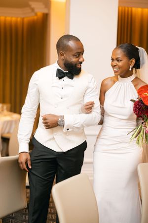 A couple shares a joyful moment together at their wedding reception.