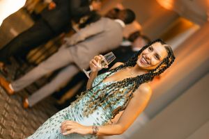Guests enjoying a festive celebration on a dance floor with warm lighting and joyful atmosphere.